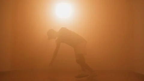 Silhouette of hipster b-boy breakdancing and doing one-hand stunt Stock Footage 132070614