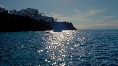 Silhouette of a hotel complex located on a hill. Beautiful sunny walkway on the Stock Footage 120108224