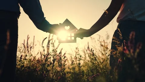 Silhouette of the house in the hands on the background of the sunset close-up Stock Footage 246686281