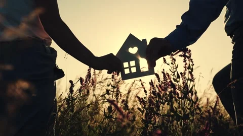 Silhouette of the house in the hands on the background of the sunset close-up Stock Footage 248934604