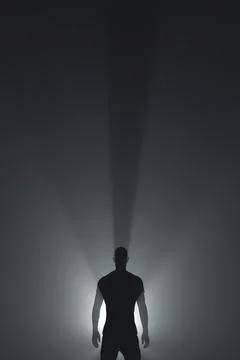 Silhouette of a human framed by rays of light Stock-Fotos
