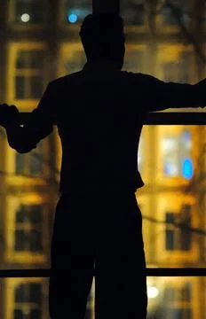 Silhouette of human in front of a window Stock Photos