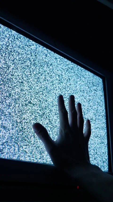 Silhouette of Human Hand Touching a Glowing Tv Screen Displaying Static Noise Stock Footage 335635317