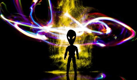 Silhouette of a humanoid with an alien head surrounded by colored lights. Stock Photos