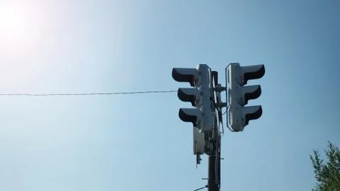 Silhouette image of traffic light with blue sky background. Stock Photos