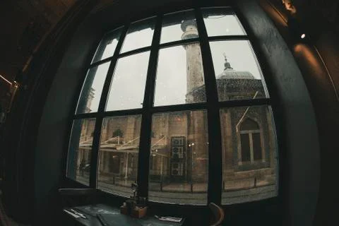 Silhouette of interior view from an empty restaurant near a mosque during a r Foto stock