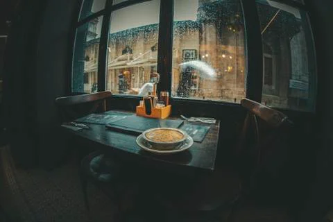Silhouette of interior view from an empty restaurant near a mosque during a r Foto stock