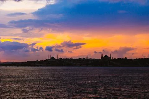 Silhouette of Istanbul at sunset with dramatic clouds. Stock Photos