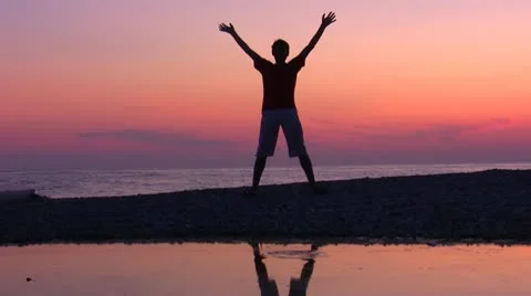 Silhouette jumping men on sundown Stock Footage 10576748