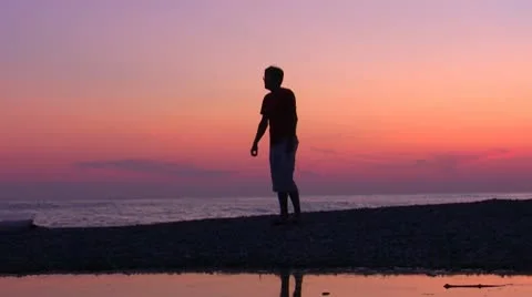 Silhouette jumping men on sundown Stock Footage 10576751