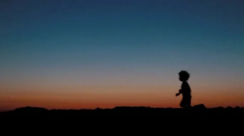 Silhouette kid running at sunset Stock Footage 41580177
