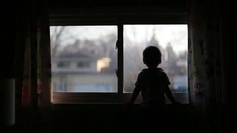 Silhouette of kid by window and falling out of frame, video Stock Footage 72789004