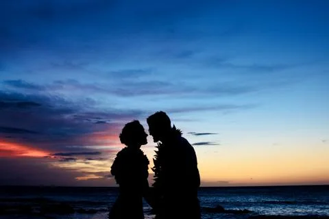 Silhouette of Kissing Couple at Dusk Stock Photos