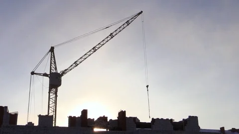 Silhouette large hoisting crane at background blue sky Stock Footage 85785498