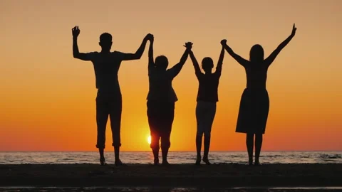 Silhouette of large multi generational family holding hands and raising arm.. Stock Footage 334518178