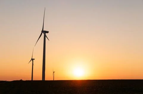 Silhouette of large wind turbine farm at sunset, Dexter, Minnesota, USA Stock Photos