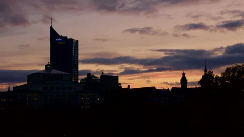 Silhouette of Leipzig Skyline under Dramatic Sky and Colorful Sunset Stock Footage 256000391