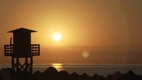 Silhouette of a lifeguard tower on the beach Видео 81761872