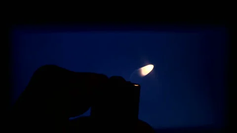 Silhouette of a Lighter on a blue background Stock Footage 196750595