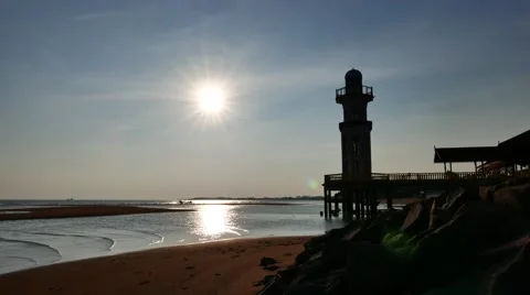 Silhouette of lighthouse, sun at background Stock Footage 50795029