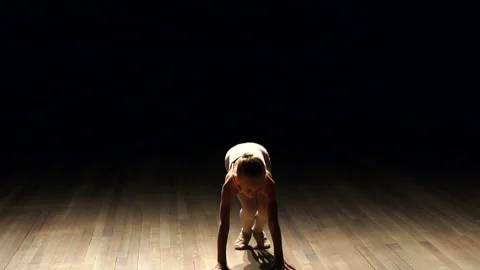 Beautiful Little Ballerina Girl Stretching on Ballet Bar at Dance