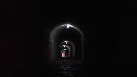 Silhouette of a local man walking through the dark, atmospheric long underg.. Vídeos de archivo 333119774