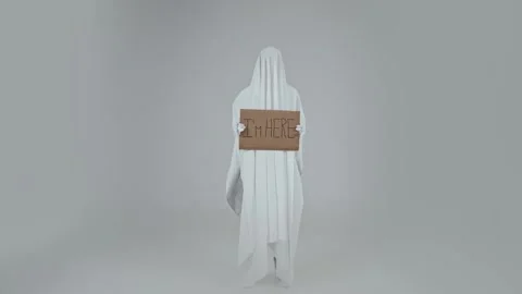 Silhouette of a lone ghost on a white background with a sign in his hands Stock Footage 287915052