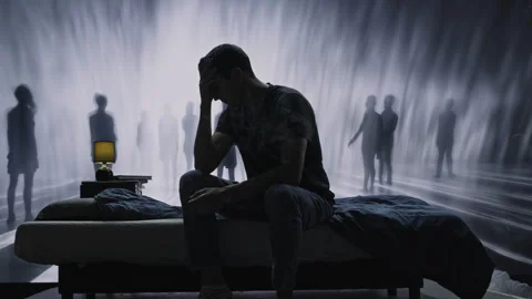 Silhouette Of Lonely Person Sitting On Bed Surrounded By Shadowy Figures Mental Video stock 288880053