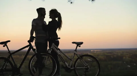 Silhouette of lovers with bicycles at sunset. Stock Footage 62496787