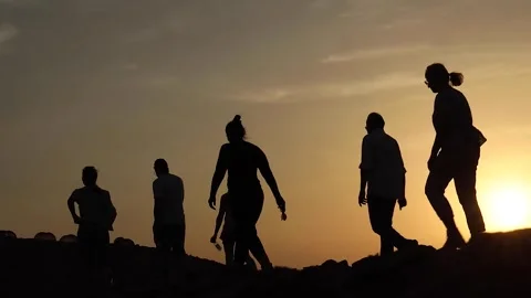 Silhouette low angle view of group people hiking along trail path in sunny day.  動画素材 280107836