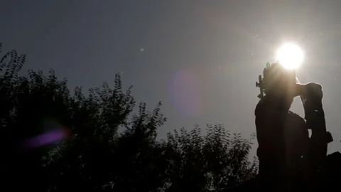 Silhouette of a man adjusts the retro camera Stock Footage 71824735