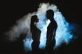 The silhouette of man and woman in the smoke Photo