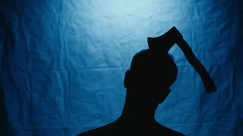 Silhouette of a man with an axe on his head on Halloween night Stock Footage 317614278