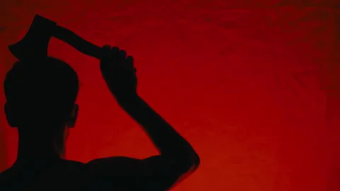 Silhouette of a man with an axe on his head on Halloween night Stock Footage 317614355