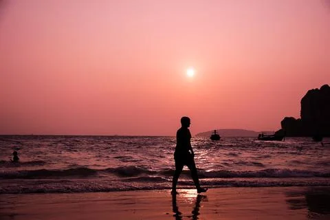 Silhouette of a Man on the Beach Stock Photos