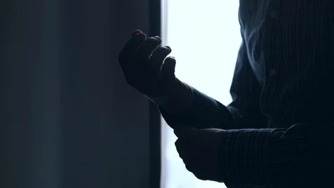 Silhouette of Man buttoning buttons on shirt sleeves. Stock Footage 106941716
