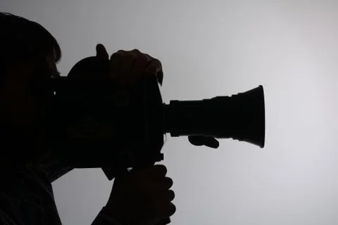 Silhouette of man camera side Stock Photos