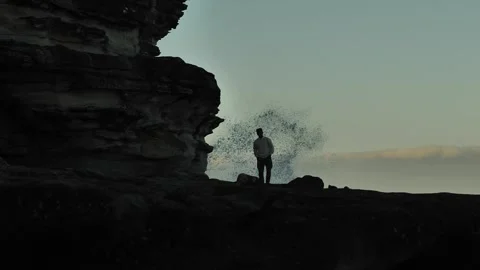 Silhouette man at cliffs in Sydney and large wave splash 4K Stock Footage 294340312