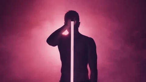 Silhouette of man dancing with lamp in smoke Stock-Footage 80597853