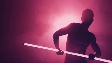 Silhouette of man dancing with lamp in smoke Video stock 80661656