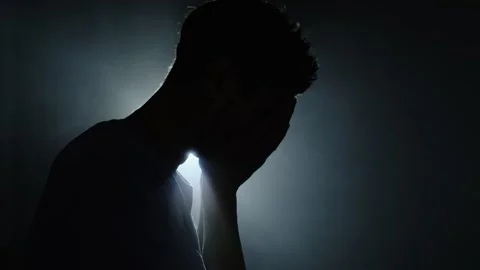 Silhouette of man in dark room with backlight thinking and searching for answers Stock-Footage 313558598