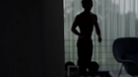 Silhouette of man in dark room dancing with headphones, Portugal Stock Footage 129065828