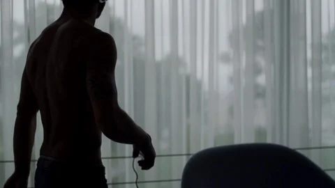Silhouette of man in dark room dancing with headphones in slow motion , Portugal Stock Footage 129065858