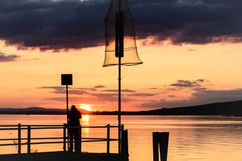 Silhouette of a man on a dock Stock Photos