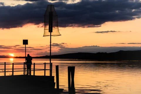 Silhouette of a man on a dock Foto stock