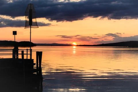 Silhouette of a man on a dock Stock Photos
