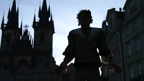 Silhouette of man doing dance moves against the background of towers and sky Stock Footage 136233597