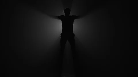 Silhouette of man doing warm up jumps before workout Stock Footage 104064861