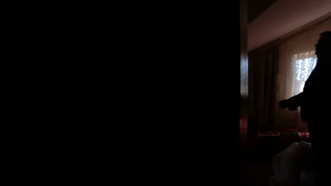 Silhouette of a man dressed in the room Stock Footage 72073390