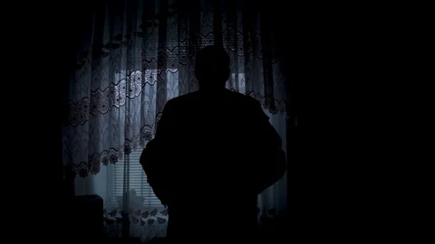 Silhouette of a man dressed in the room Stock Footage 90759744